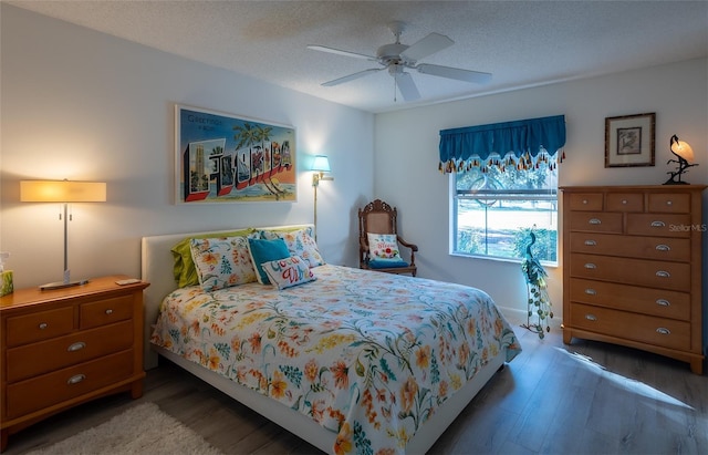 bedroom with a textured ceiling, ceiling fan, and hardwood / wood-style flooring