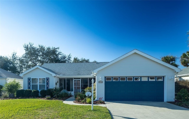 ranch-style house featuring a front lawn and a garage