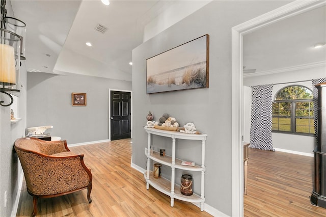 interior space with crown molding and light hardwood / wood-style flooring