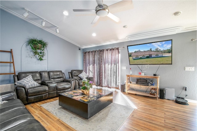 living room featuring wood-type flooring, ornamental molding, and ceiling fan