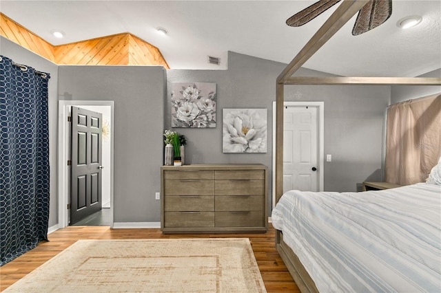 bedroom featuring lofted ceiling, light wood-type flooring, and ceiling fan