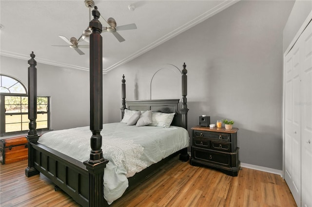 bedroom featuring crown molding, ceiling fan, wood-type flooring, and a closet