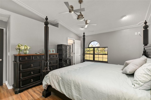 bedroom with ceiling fan, ornamental molding, light hardwood / wood-style floors, and vaulted ceiling