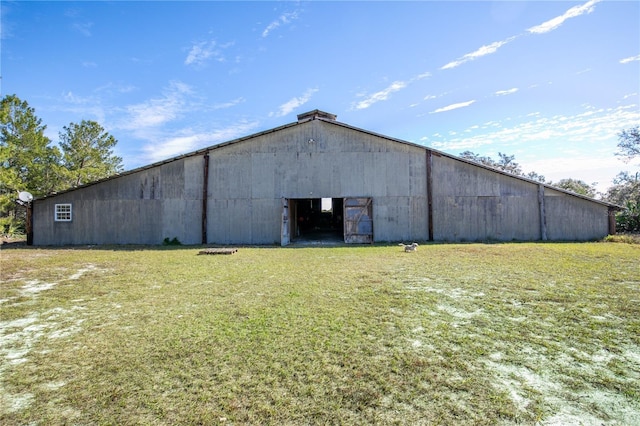 view of outdoor structure featuring a lawn