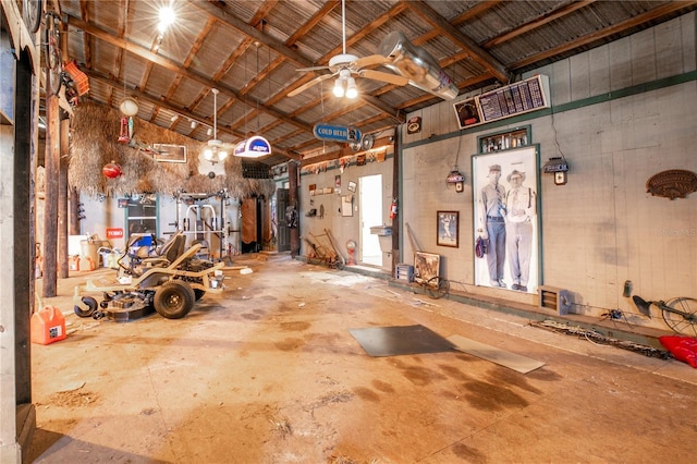 miscellaneous room featuring concrete flooring, ceiling fan, and high vaulted ceiling