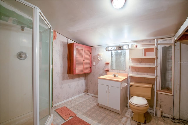 bathroom featuring vanity, toilet, and walk in shower