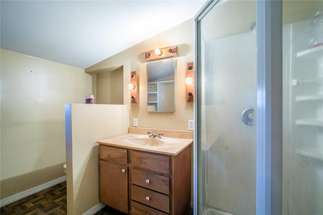 bathroom with toilet, vaulted ceiling, parquet floors, vanity, and a shower with door