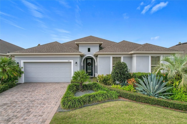 view of front of property with a front lawn and a garage