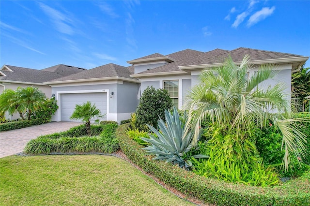 view of front facade featuring a garage and a front lawn