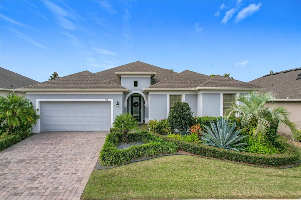 view of front of home with a garage and a front yard