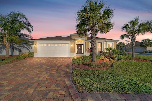 view of front of property featuring a garage and a yard