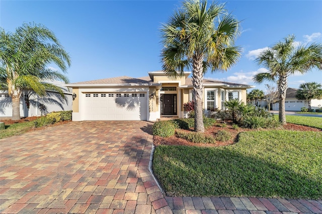 view of front of house featuring a front yard and a garage