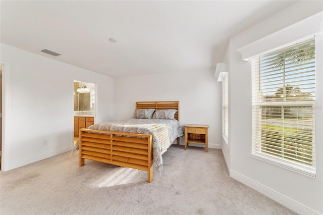 carpeted bedroom with connected bathroom