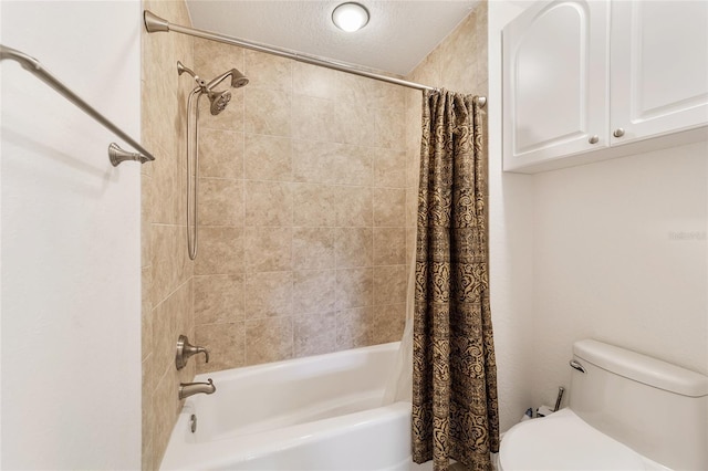 bathroom featuring a textured ceiling, shower / bath combo, and toilet