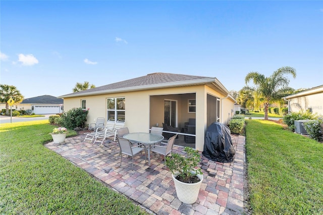 rear view of property with a patio, cooling unit, and a lawn