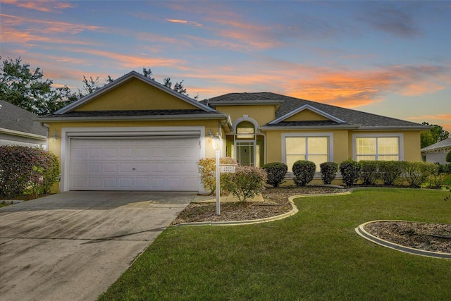 ranch-style home with a lawn and a garage