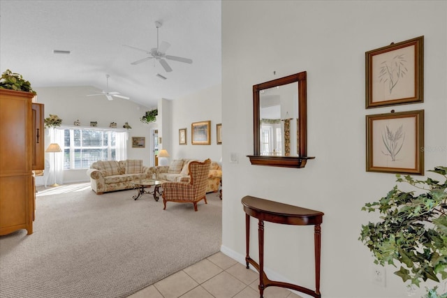 carpeted living room with vaulted ceiling and ceiling fan