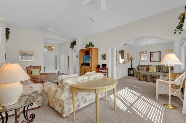 carpeted living room featuring ceiling fan, lofted ceiling, and decorative columns