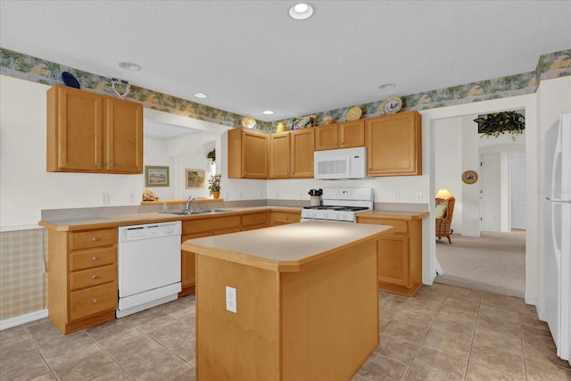 kitchen with a kitchen island, light colored carpet, white appliances, and sink