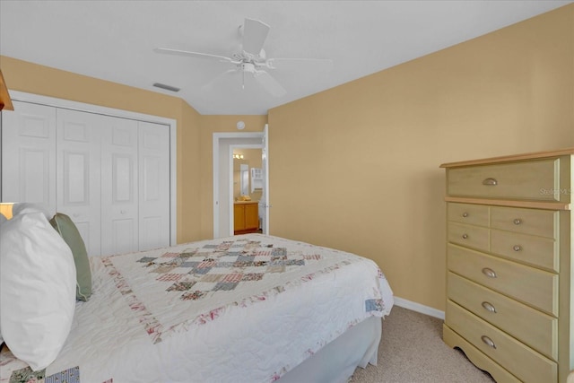 bedroom featuring ceiling fan, a closet, and light colored carpet