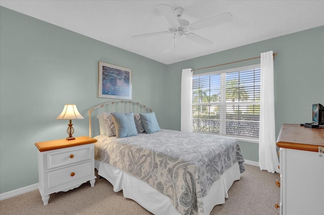 bedroom featuring light carpet and ceiling fan