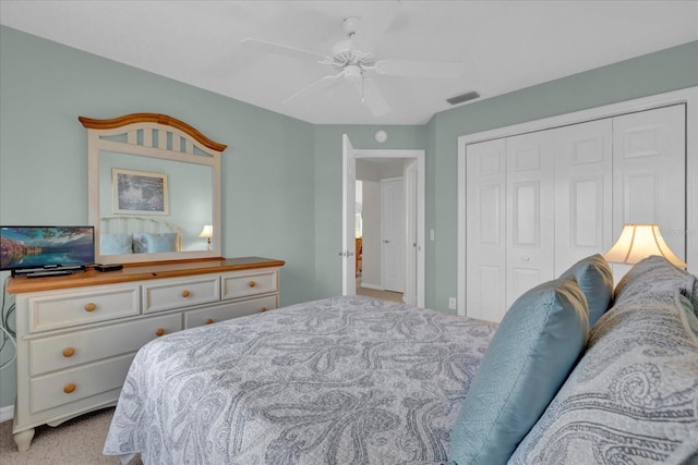 bedroom featuring light carpet, a closet, and ceiling fan