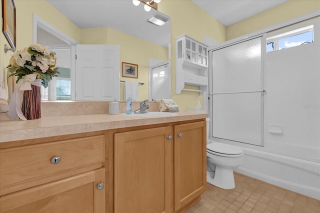 full bathroom with vanity, toilet, and enclosed tub / shower combo