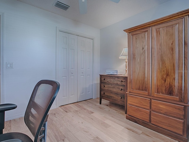 office featuring light hardwood / wood-style floors and ceiling fan