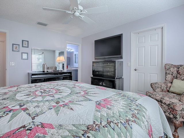 bedroom featuring a textured ceiling, ceiling fan, and ensuite bath