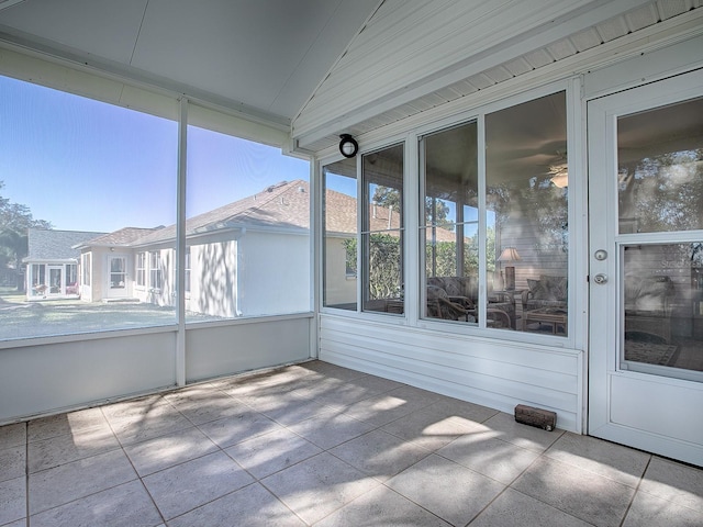 unfurnished sunroom with vaulted ceiling