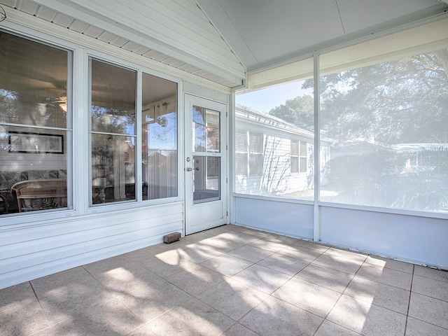 unfurnished sunroom featuring lofted ceiling