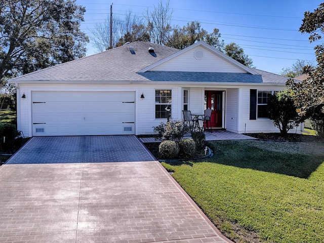 ranch-style house with a garage and a front lawn