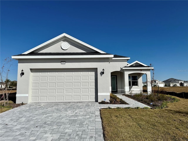 ranch-style home with a garage and a front lawn