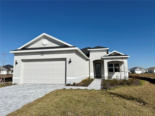 view of front of property with a garage and a front lawn