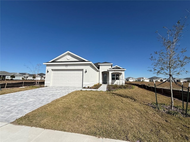 view of front facade with a garage and a front lawn