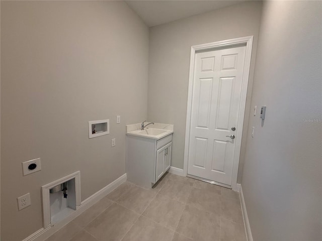 clothes washing area featuring cabinets, washer hookup, electric dryer hookup, sink, and light tile patterned floors