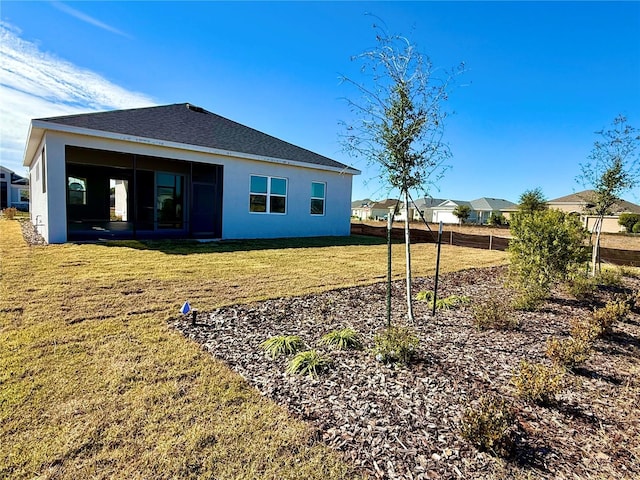 rear view of property with a yard