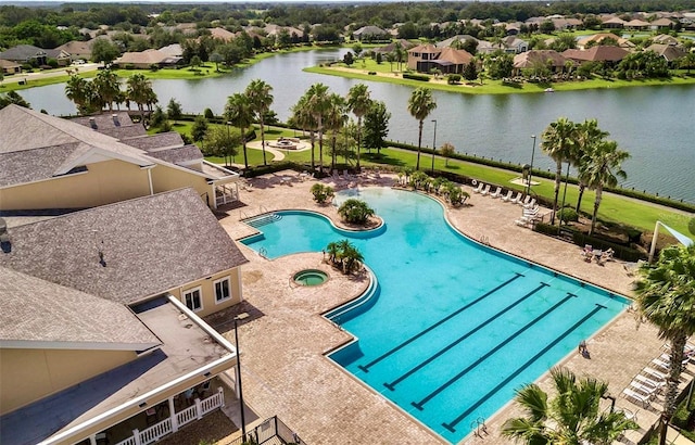 view of swimming pool with a water view and a patio