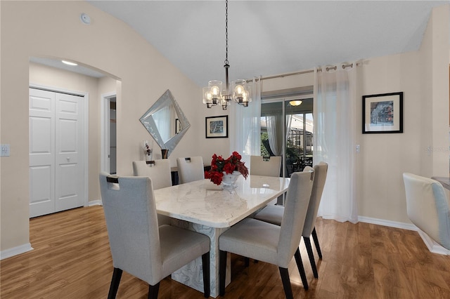 dining room with a chandelier and hardwood / wood-style floors