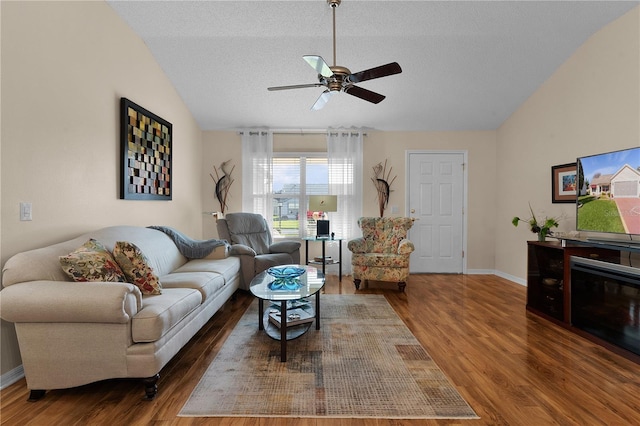 living room featuring ceiling fan, dark wood-type flooring, a textured ceiling, and lofted ceiling