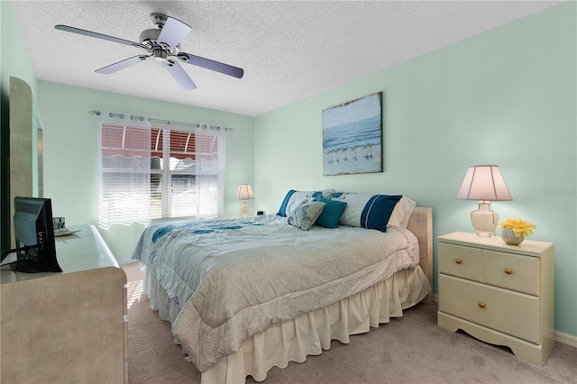 carpeted bedroom with a textured ceiling and ceiling fan