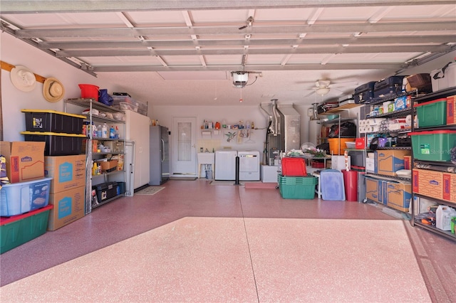 garage featuring a garage door opener, stainless steel refrigerator, and washing machine and clothes dryer