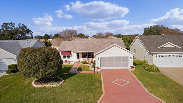 ranch-style house featuring a front lawn and a garage