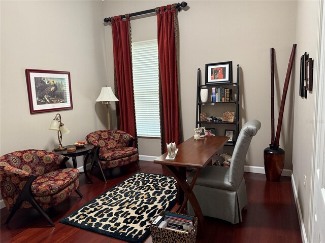 home office with dark wood-type flooring and a healthy amount of sunlight