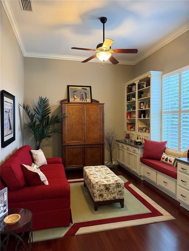 sitting room featuring dark hardwood / wood-style flooring, ceiling fan, and ornamental molding