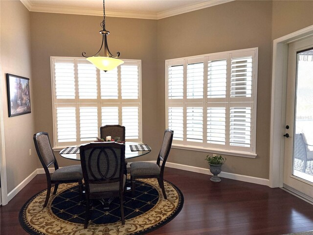 dining area featuring ornamental molding and dark wood-type flooring