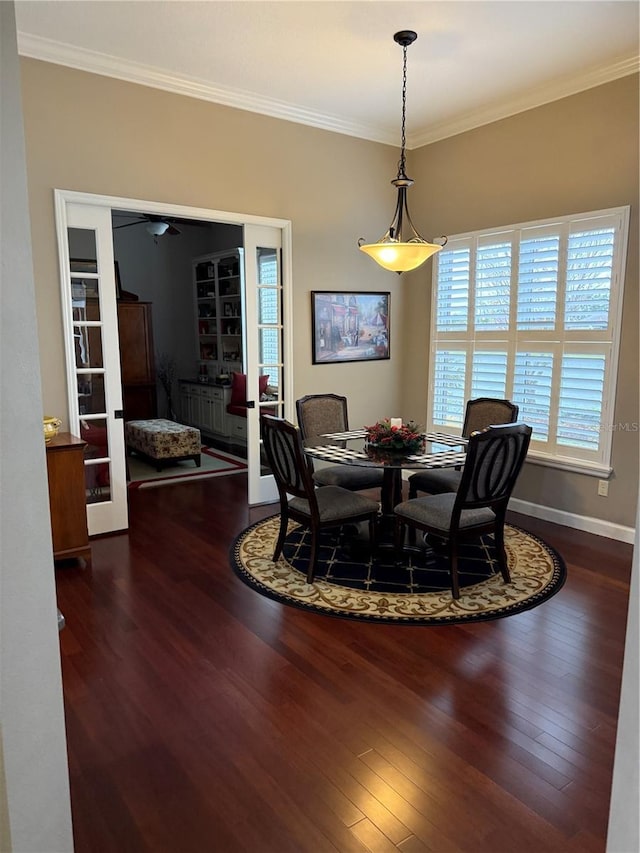 dining space with dark hardwood / wood-style flooring and crown molding