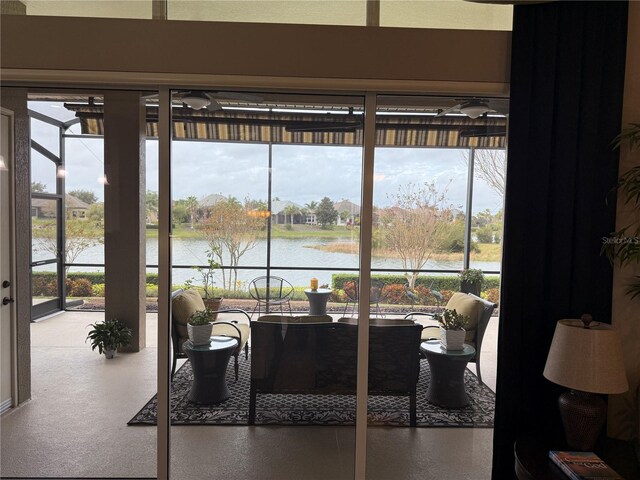 sunroom / solarium featuring a water view and a wealth of natural light