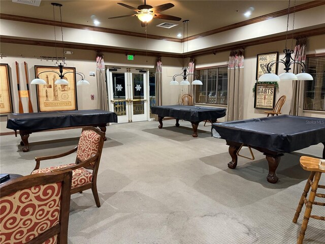 rec room with french doors, ceiling fan, ornamental molding, pool table, and light colored carpet