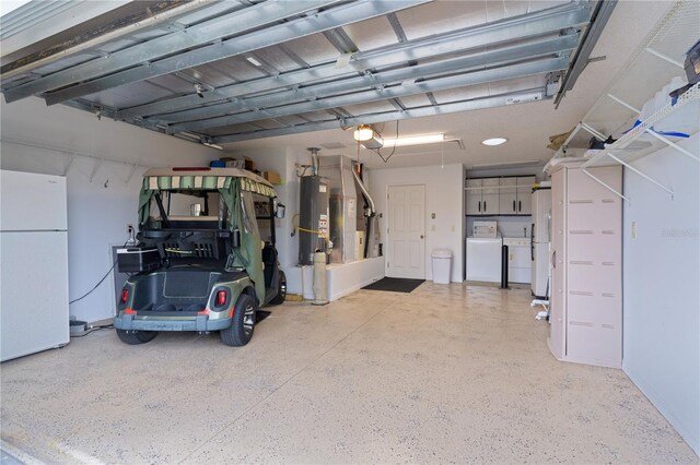 garage with gas water heater, independent washer and dryer, white fridge, and a garage door opener